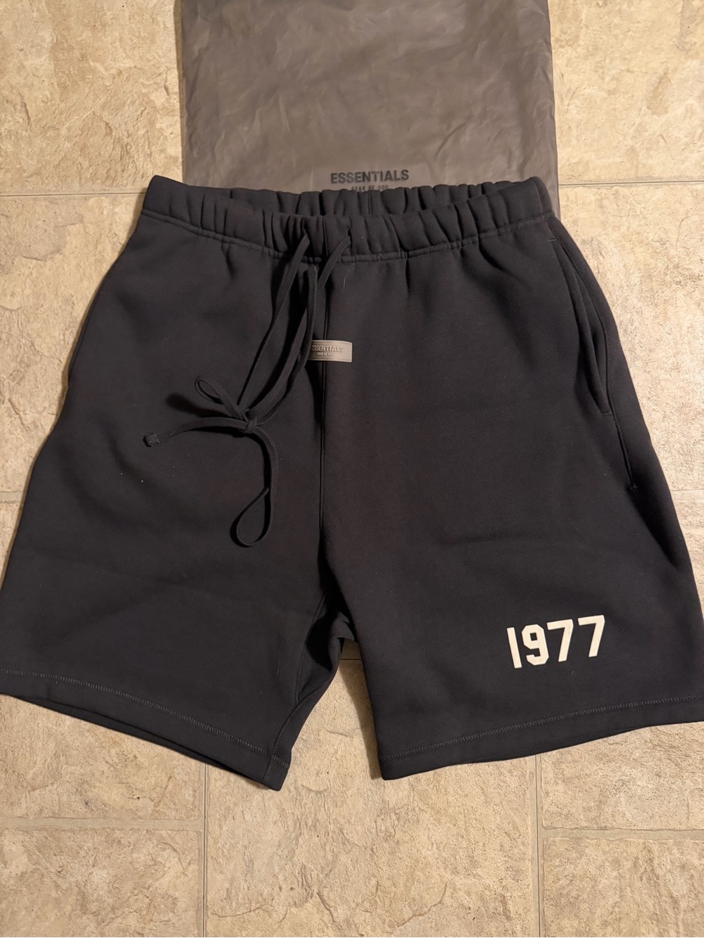 Fear of God ESSENTIALS Men’s Black Shorts with 1977 Print